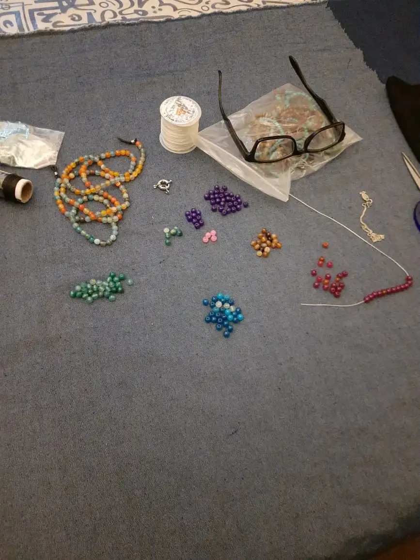 Abeer is making bracelets instead of sewing.
