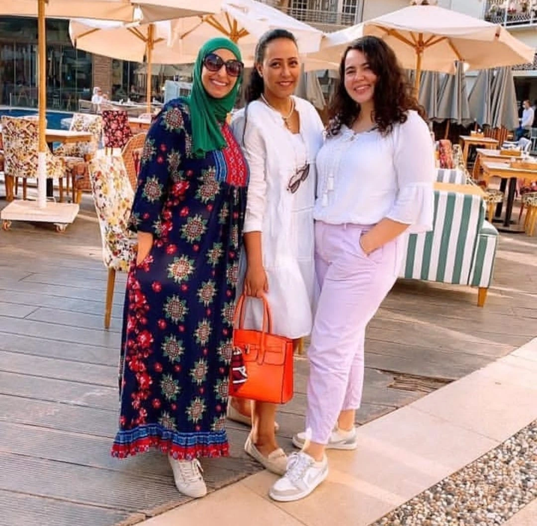 Abeer wearing one of her dresses and posing together with friends.